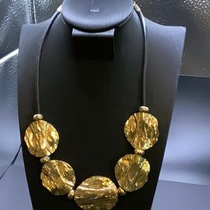 Gold tone metal and black rubber necklace adjustable up to 17”